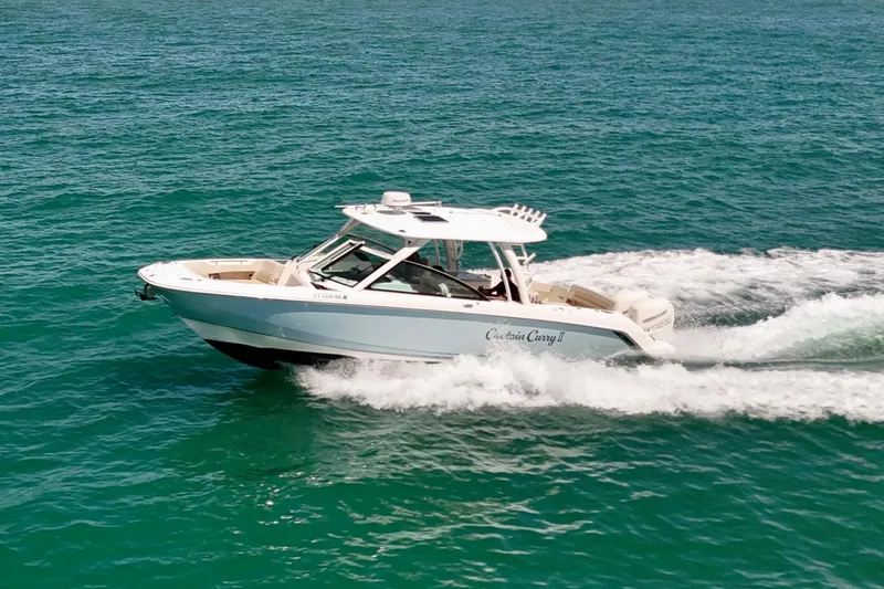 Slide: The Image of 2018 Boston Whaler 320 Vantage cruising on open water. - 33