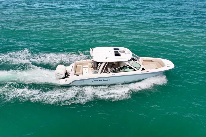 Slide: The Image of 2018 Boston Whaler 320 Vantage cruising on clear blue ocean waters. - 34