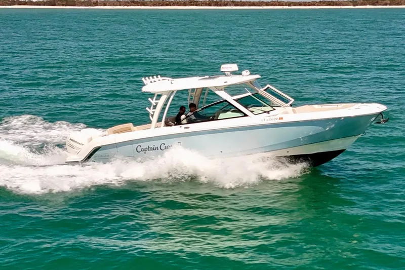Slide: The Image of 2018 Boston Whaler 320 Vantage cruising on open water. - 36