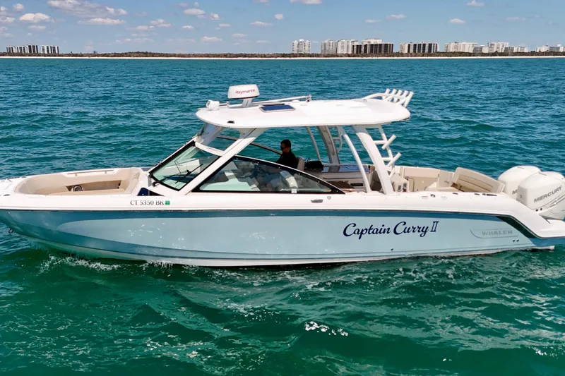 Slide: The Image of 2018 Boston Whaler 320 Vantage boat "Captain Curry II" cruising on clear blue water. - 38