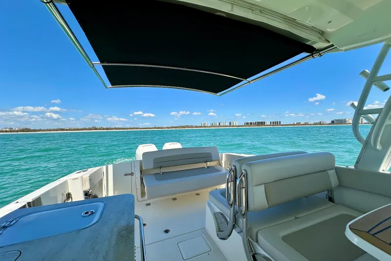Slide: The Image of 2018 Boston Whaler 320 Vantage boat interior with ocean view and canopy. - 4