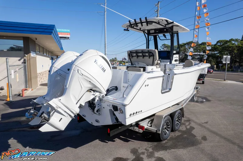 Slide: The Image of 2026 Sea Hunt Gamefish 25 boat with dual Yamaha engines on a trailer. - 14