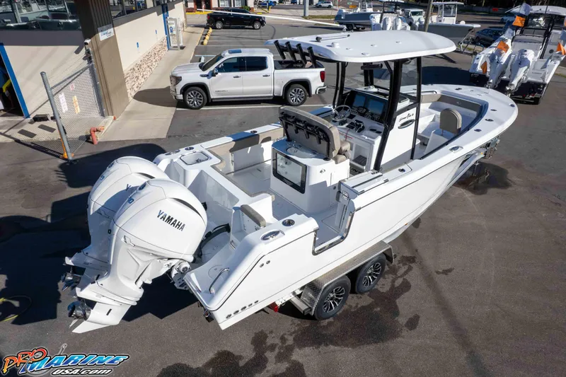 Slide: The Image of 2026 Sea Hunt Gamefish 25 boat with Yamaha engines in a dealership lot. - 16