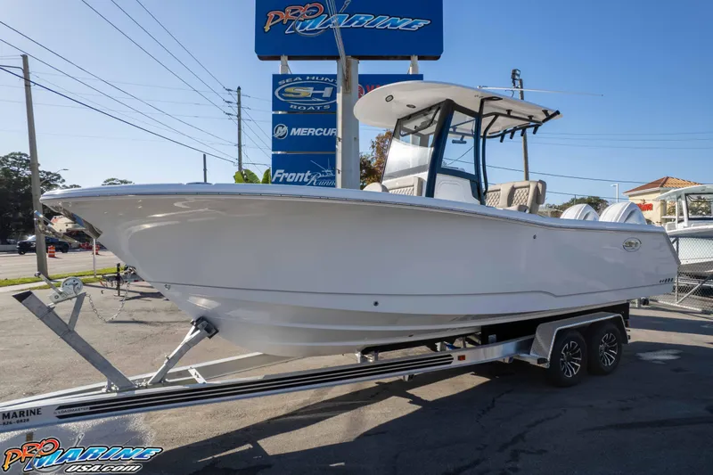Slide: The Image of 2026 Sea Hunt Gamefish 25 boat on trailer at dealership. - 2