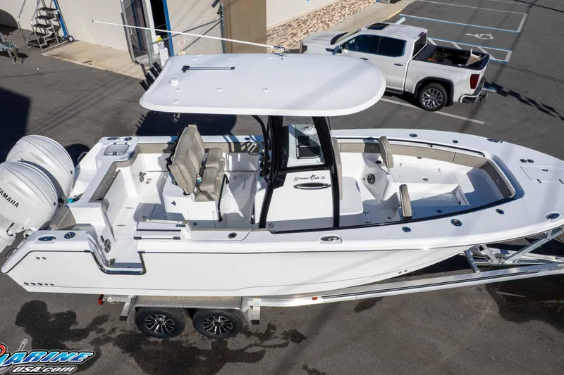 Slide: The Image of 2026 Sea Hunt Gamefish 25 boat on trailer, featuring dual Yamaha engines. - 24