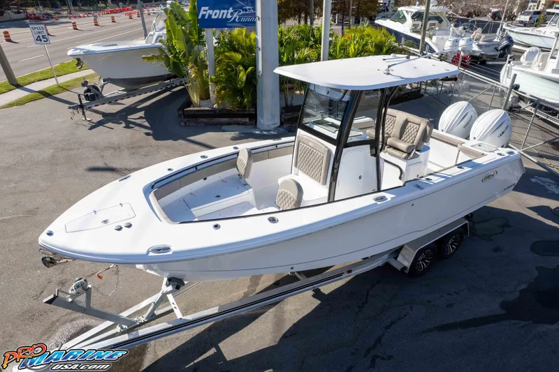 Slide: The Image of 2026 Sea Hunt Gamefish 25 boat on trailer at dealership, sunny day. - 3