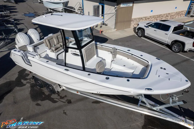 Slide: The Image of 2026 Sea Hunt Gamefish 25 boat on trailer, parked in marina lot. - 30