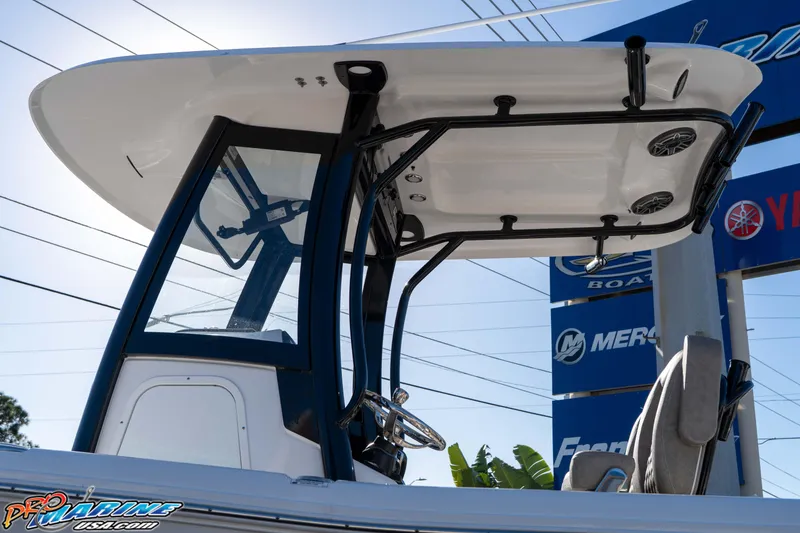 Slide: The Image of 2026 Sea Hunt Gamefish 25 boat with T-top and steering console, displayed outdoors. - 39