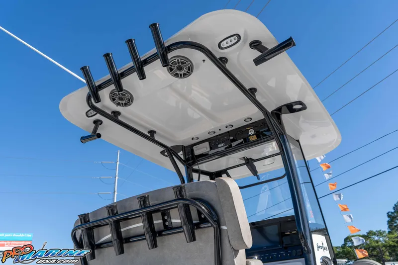 Slide: The Image of 2026 Sea Hunt Gamefish 25 boat with rod holders and speakers under a clear blue sky. - 43