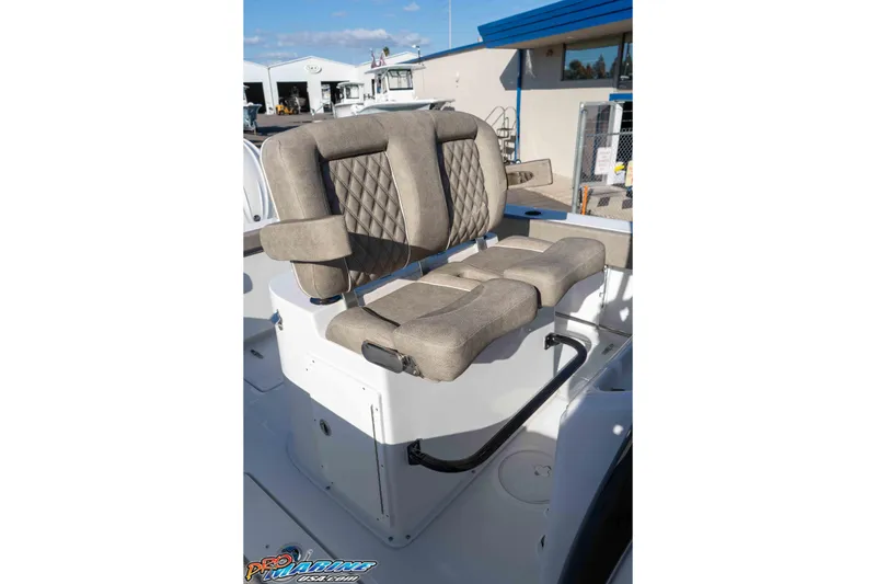 Slide: The Image of 2026 Sea Hunt Gamefish 25 boat seating with diamond-stitched upholstery in a marina setting. - 50