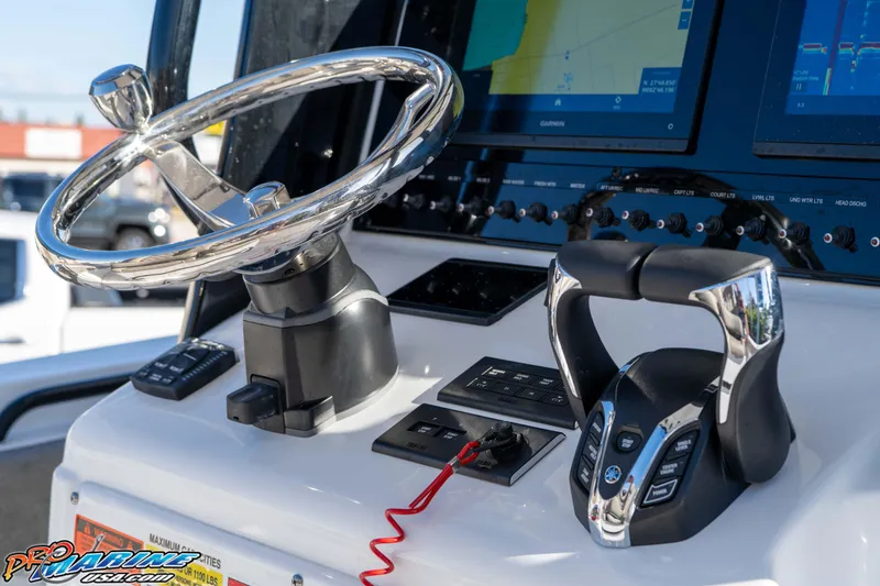 Slide: The Image of 2026 Sea Hunt Gamefish 25 helm with steering wheel and control panel. - 53