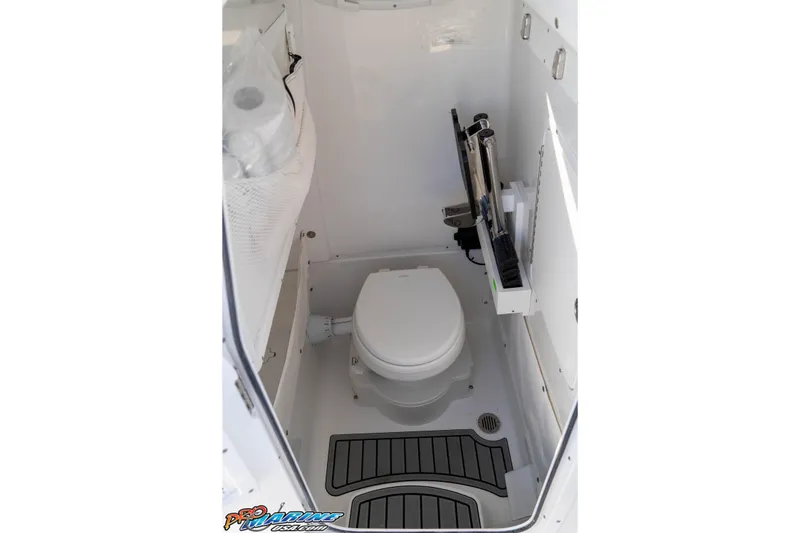 Slide: The Image of 2026 Sea Hunt Gamefish 25 boat interior with compact marine toilet. - 57