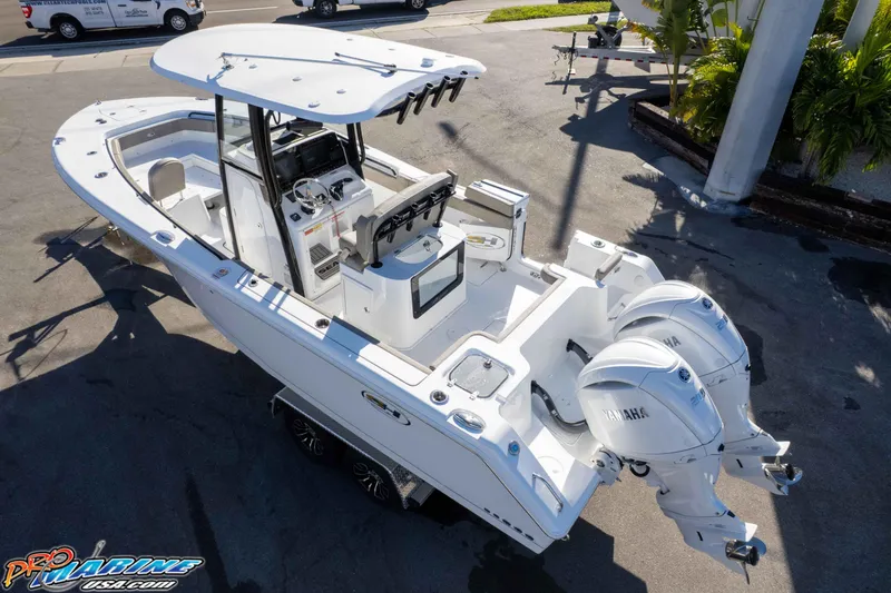 Slide: The Image of 2026 Sea Hunt Gamefish 25 boat with dual Yamaha engines, parked on a trailer. - 8