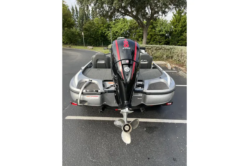 Slide: The Image of 2024 Nitro Z18 boat with powerful outboard motor in a parking lot. - 3