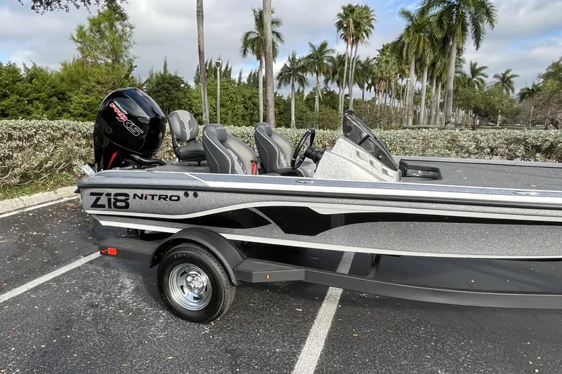 Slide: The Image of 2024 Nitro Z18 boat parked with palm trees in the background. - 4