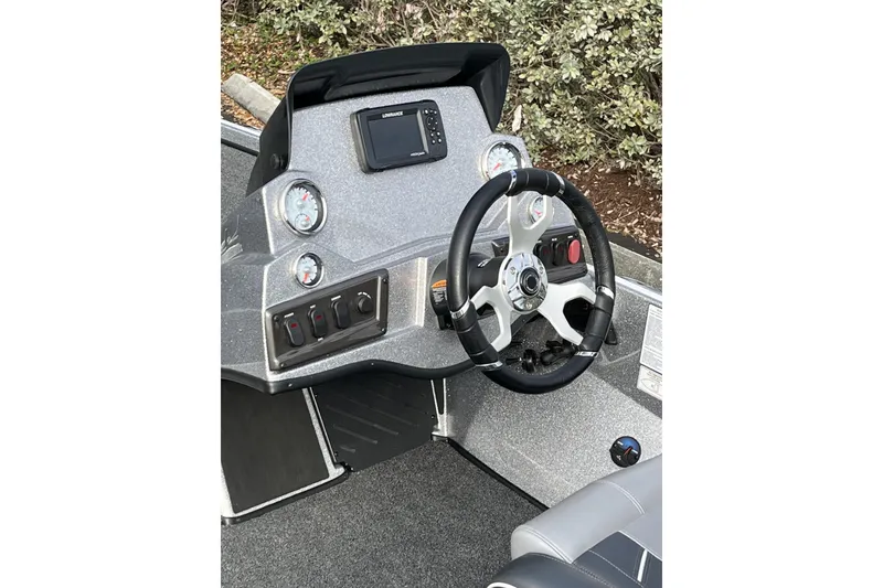Slide: The Image of 2024 Nitro Z18 boat dashboard with steering wheel and control panel. - 9