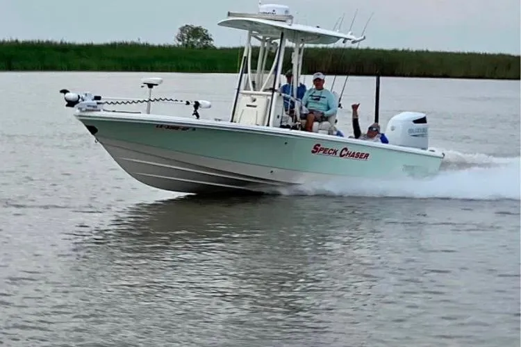 The Image of 2016 Pathfinder 2600 HPS boat named "Speck Chaser" cruising on a calm waterway. - 0