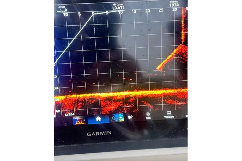 Slide: The Image of 2016 Pathfinder 2600 HPS boat interior with storage compartments and measuring scale. - 11