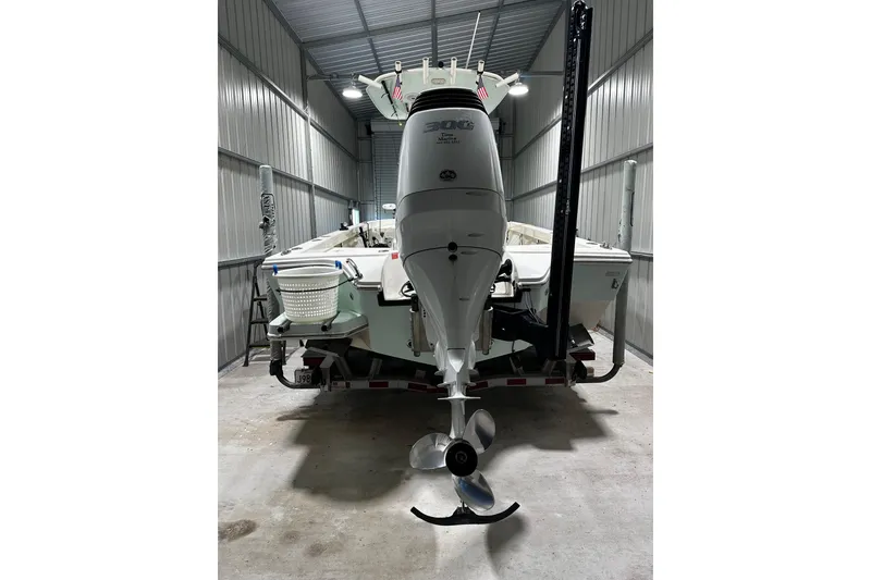 Slide: The Image of 2016 Pathfinder 2600 HPS boat in storage, rear view with outboard motor. - 16