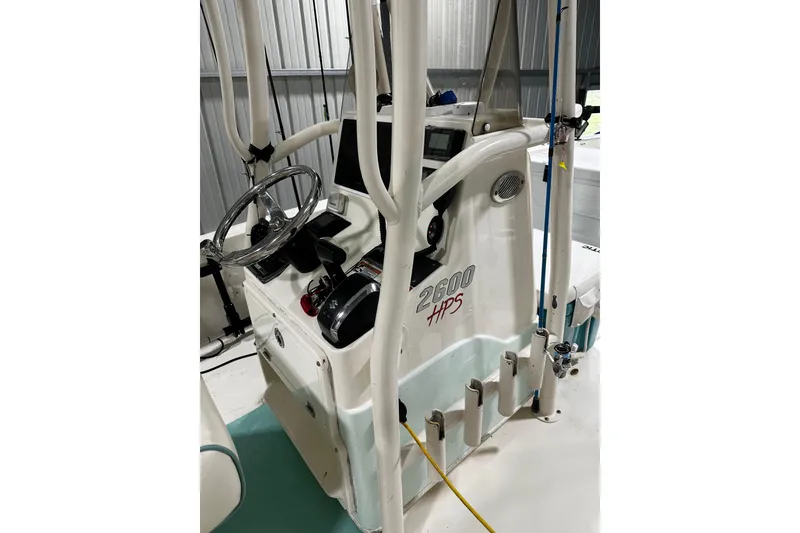 Slide: The Image of 2016 Pathfinder 2600 HPS boat console with steering wheel and controls in a storage area. - 18