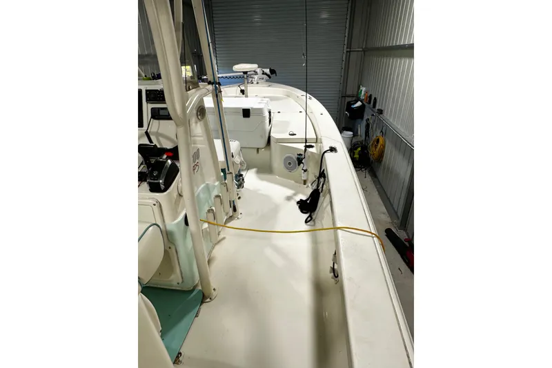 Slide: The Image of 2016 Pathfinder 2600 HPS boat interior in storage, showcasing deck and equipment. - 19