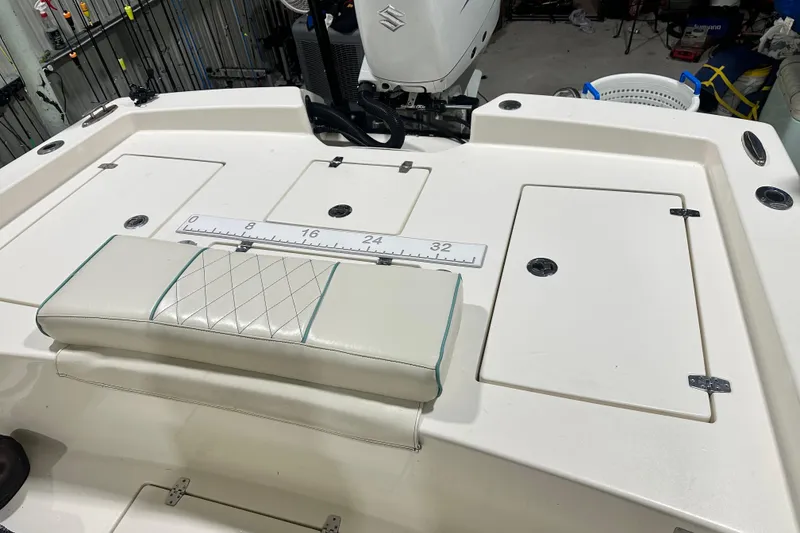 Slide: The Image of 2016 Pathfinder 2600 HPS boat interior with storage compartments and measuring ruler. - 21