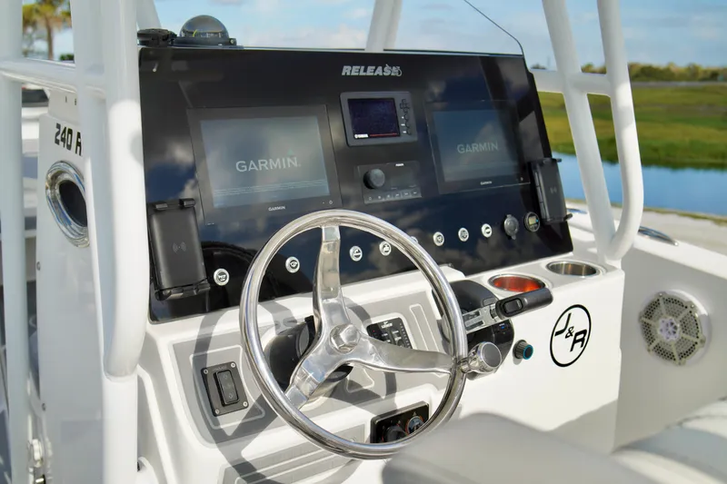 Slide: The Image of Helm of 2017 Release 240 RX boat with Garmin navigation system and steering wheel. - 17