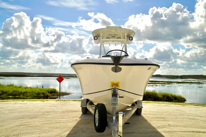 Slide: The Image of 2017 Release 240 RX boat on trailer by scenic lake under cloudy sky. - 3