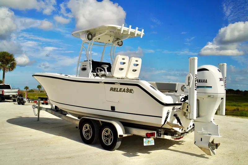 Slide: The Image of 2017 Release 240 RX boat on trailer, featuring Yamaha engine, under a blue sky. - 30