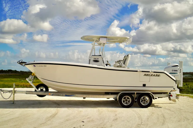 Slide: The Image of 2017 Release 240 RX boat on trailer under cloudy sky. - 5