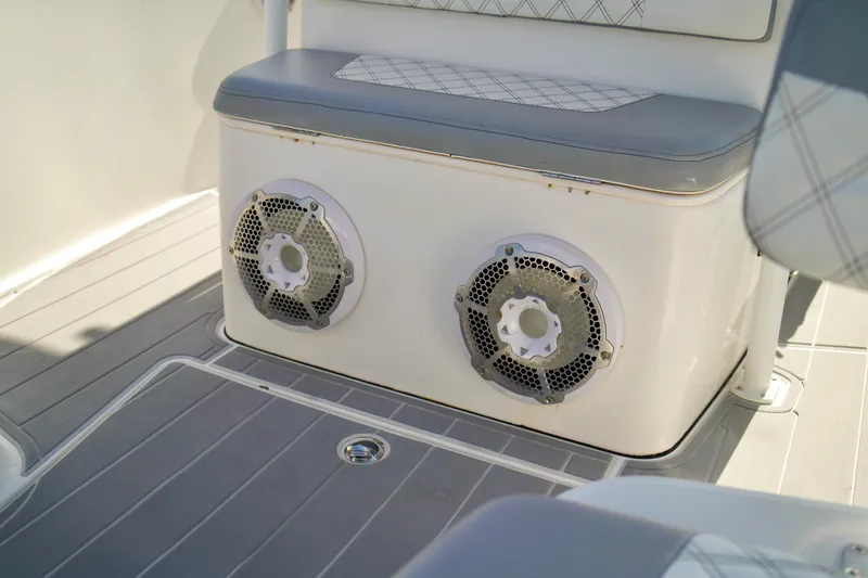 Slide: The Image of 2017 Release 240 RX boat interior with dual speakers and cushioned seating. - 9