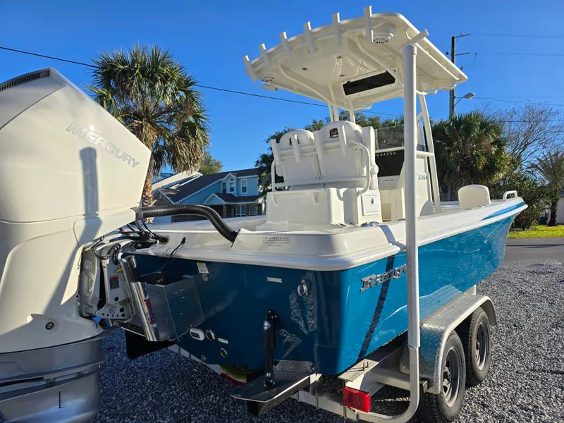 Slide: The Image of 2025 Ranger 2360 Bay boat on trailer, featuring a powerful outboard motor. - 4