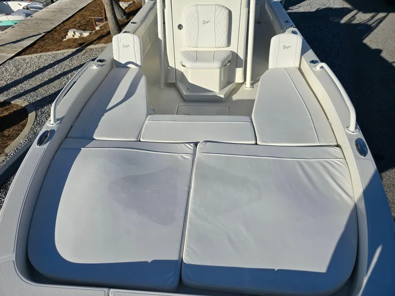 Slide: The Image of 2025 Ranger 2360 Bay boat interior with white cushioned seating. - 7