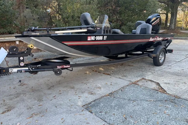 Slide: The Image of 2023 Tracker Bass Tracker Classic XL boat on trailer, parked outdoors. - 2