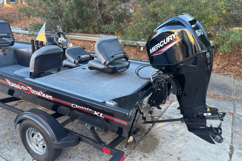 Slide: The Image of 2023 Tracker Bass Tracker Classic XL boat with Mercury 50 engine, parked outdoors. - 3