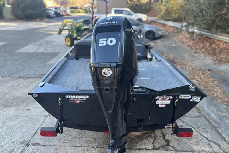 Slide: The Image of 2023 Tracker Bass Tracker Classic XL boat with Mercury 50 engine, parked on a driveway. - 4