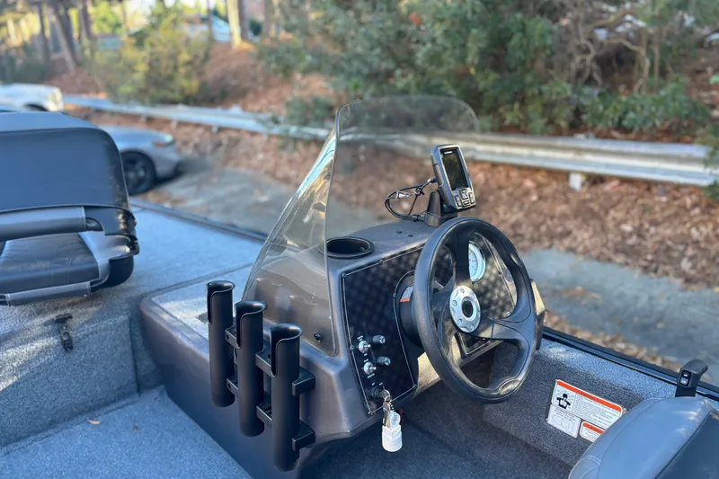 Slide: The Image of 2023 Tracker Bass Tracker Classic XL boat dashboard with steering wheel and fish finder. - 5