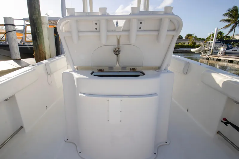 Slide: The Image of 2014 Sea Hunt Gamefish 25 boat interior with open storage compartment at marina. - 16