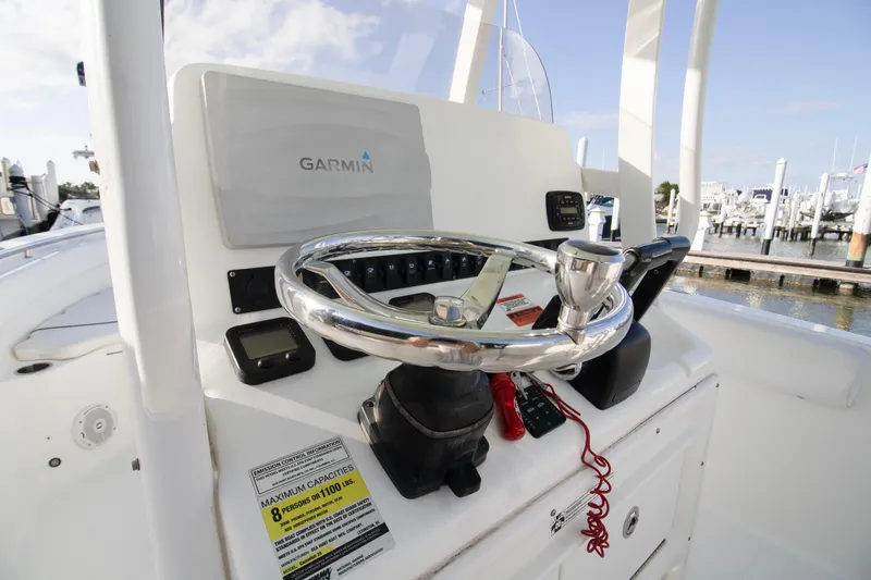 Slide: The Image of 2014 Sea Hunt Gamefish 25 boat console with Garmin navigation system and steering wheel. - 8