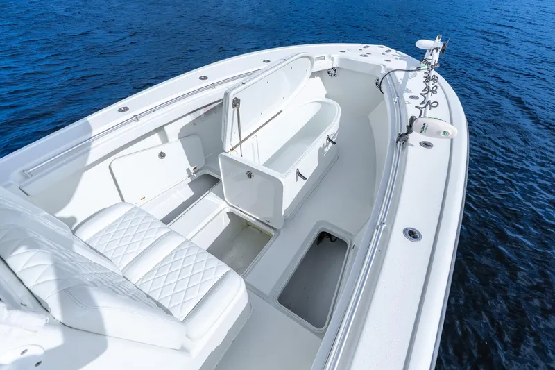 Slide: The Image of 2014 Yellowfin 32 Offshore boat interior with white seating and storage compartments. - 15