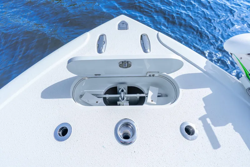 Slide: The Image of Bow of 2014 Yellowfin 32 Offshore boat with anchor compartment open. - 17