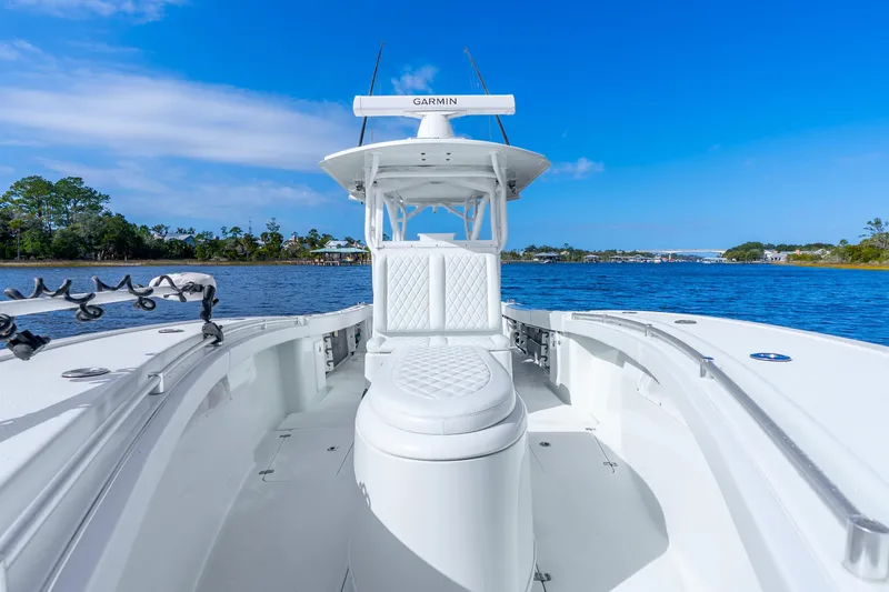 Slide: The Image of 2014 Yellowfin 32 Offshore boat on calm water under clear blue sky. - 19
