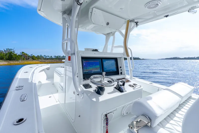Slide: The Image of 2014 Yellowfin 32 Offshore boat interior with navigation system on a sunny day. - 22