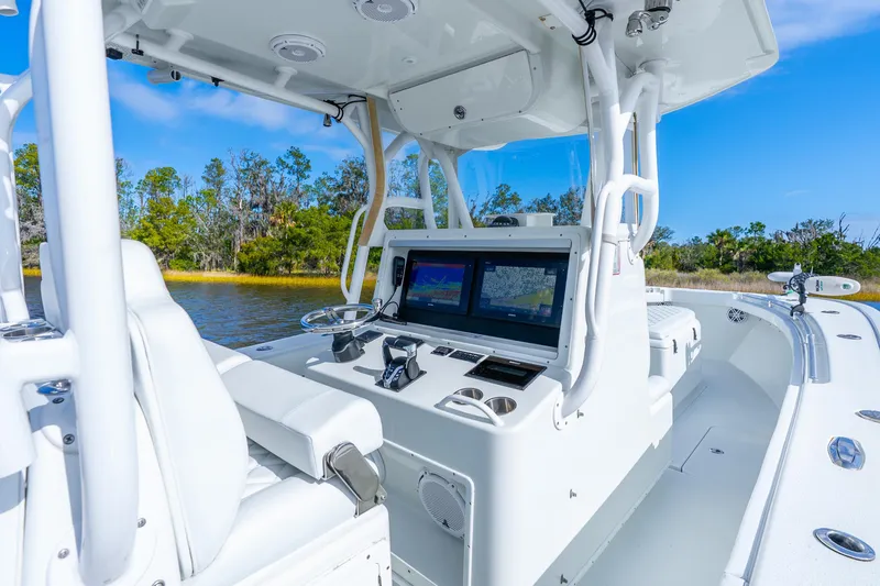 Slide: The Image of 2014 Yellowfin 32 Offshore boat interior with navigation screens and steering wheel. - 24