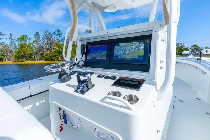 Slide: The Image of 2014 Yellowfin 32 Offshore boat console with dual navigation screens on a sunny day. - 25