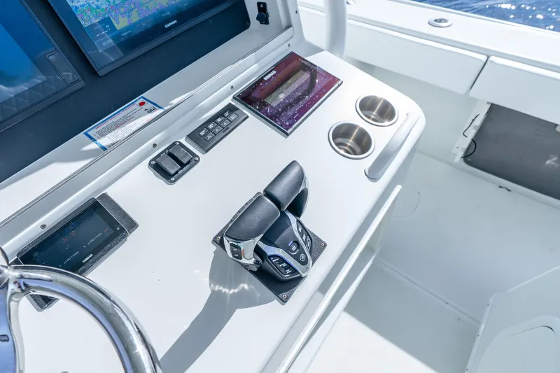 Slide: The Image of Control panel of 2014 Yellowfin 32 Offshore boat with navigation screens and throttle. - 28