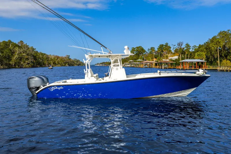 Slide: The Image of 2014 Yellowfin 32 Offshore boat on a scenic river with blue skies. - 3