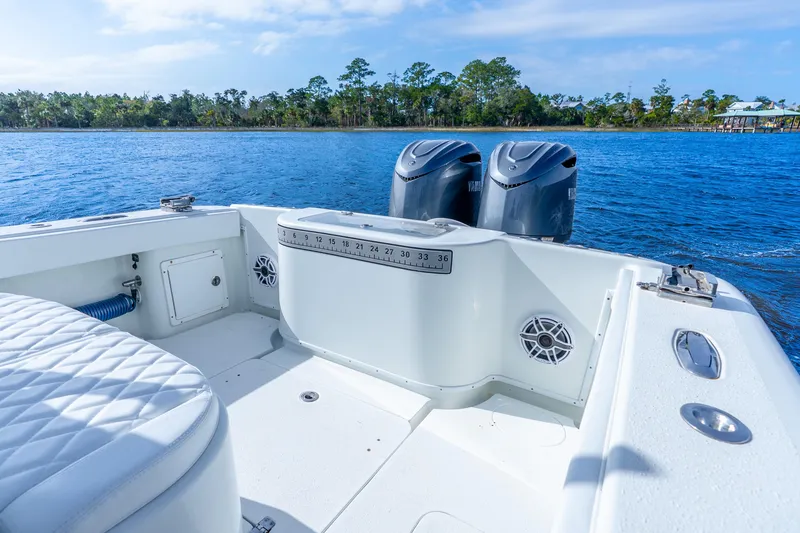 Slide: The Image of 2014 Yellowfin 32 Offshore boat with dual engines on a serene lake. - 35