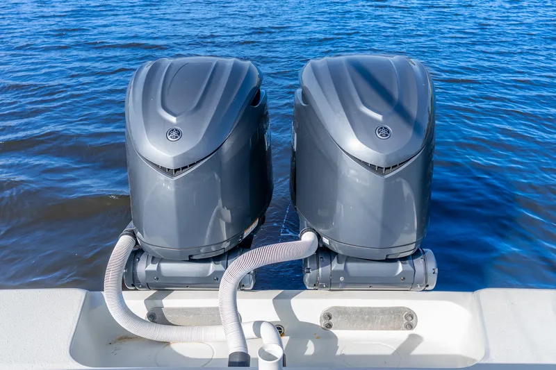 Slide: The Image of Twin outboard motors on a 2014 Yellowfin 32 Offshore boat in blue water. - 37