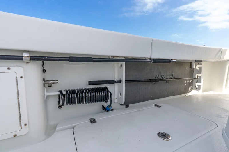 Slide: The Image of 2014 Yellowfin 32 Offshore boat interior with rod storage and coiled hose. - 38
